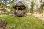 Gazebo with bench swing, located in the backyard with views of the Spring River and surrounding scenery